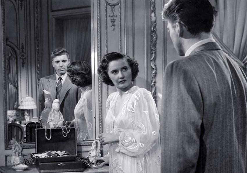 event image:A man and a woman looking at each other and reflecting in a mirror